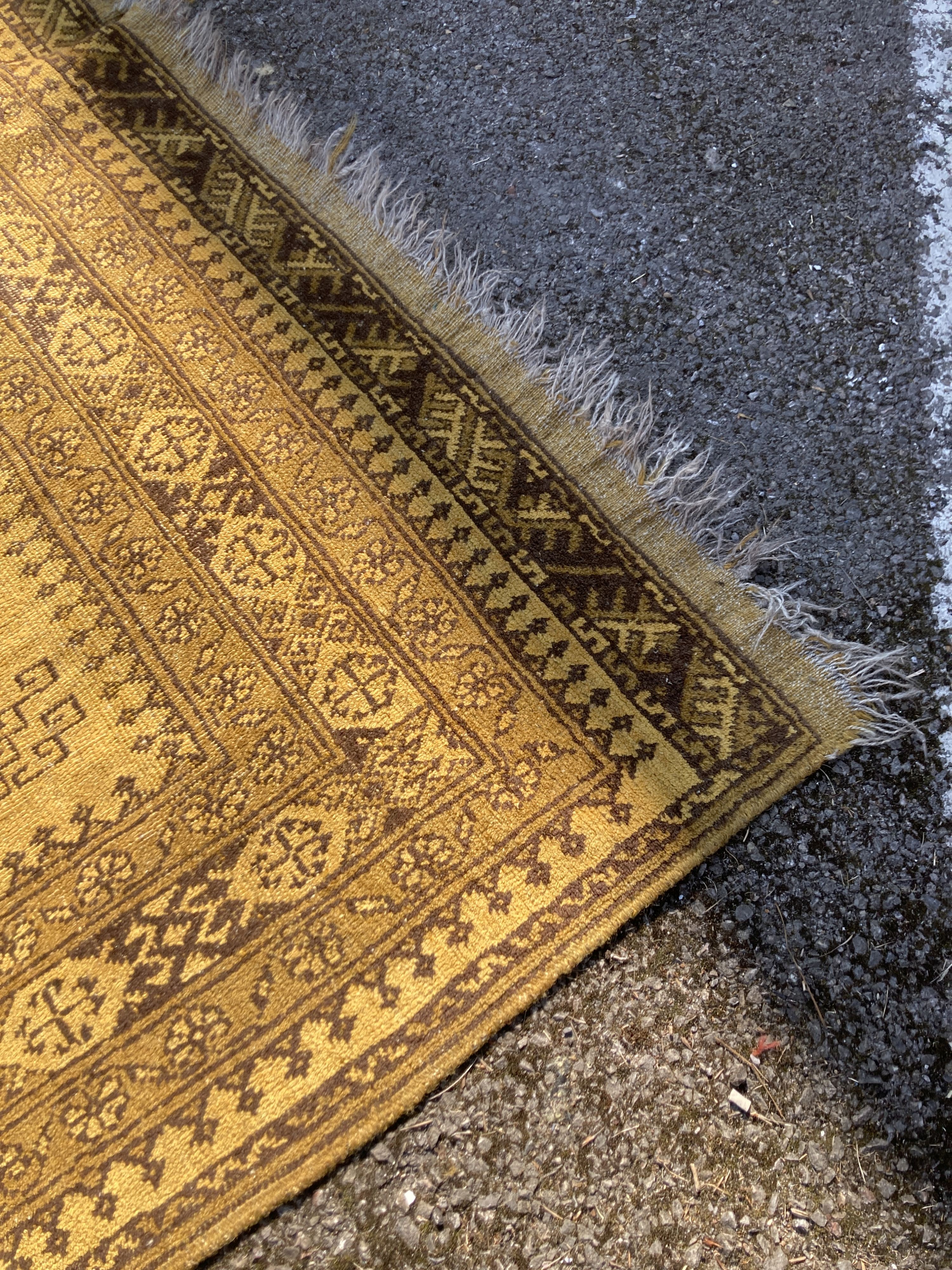 An Afghan gold ground carpet, 300 x 200cm